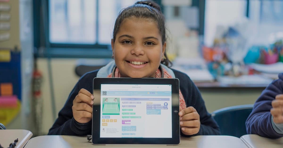 Girl holding iPad showcasing Code.org learning program