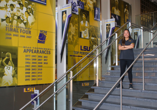 Sport Admin student standing on steps at basketball arean