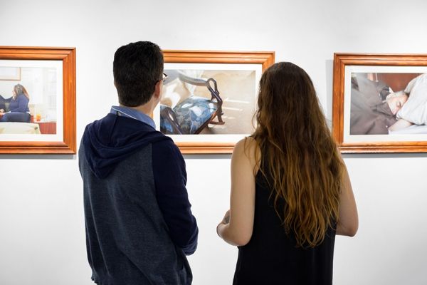 professor and student look at art