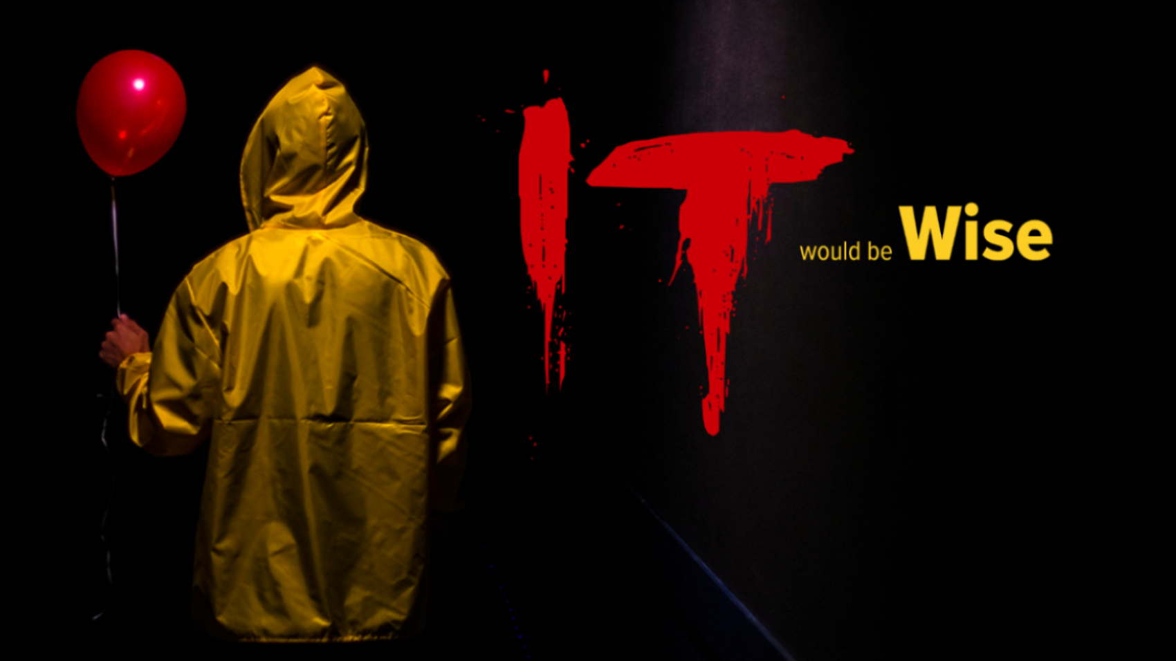 Man in yellow jacket holding balloon