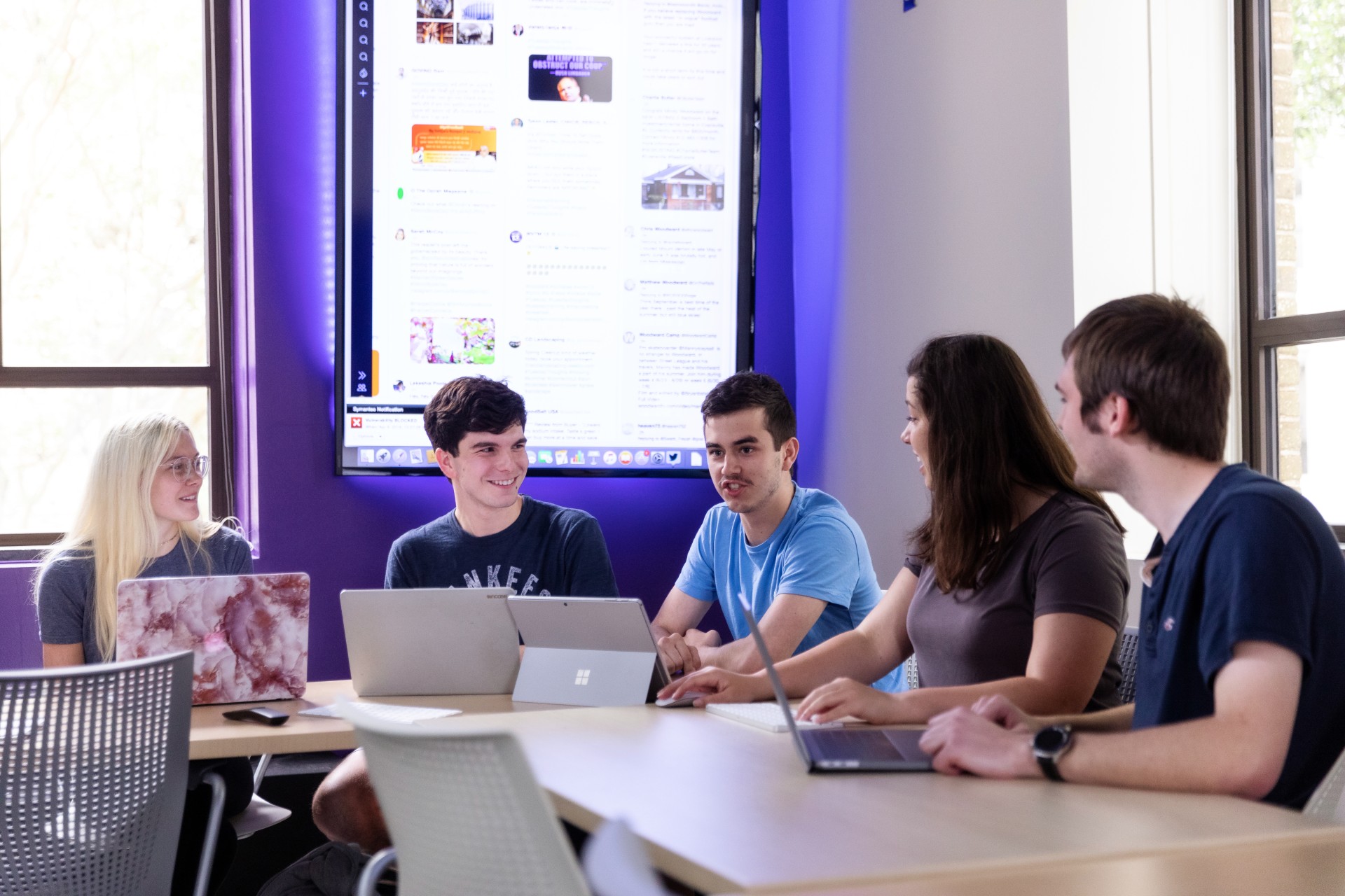 Students around a table talking